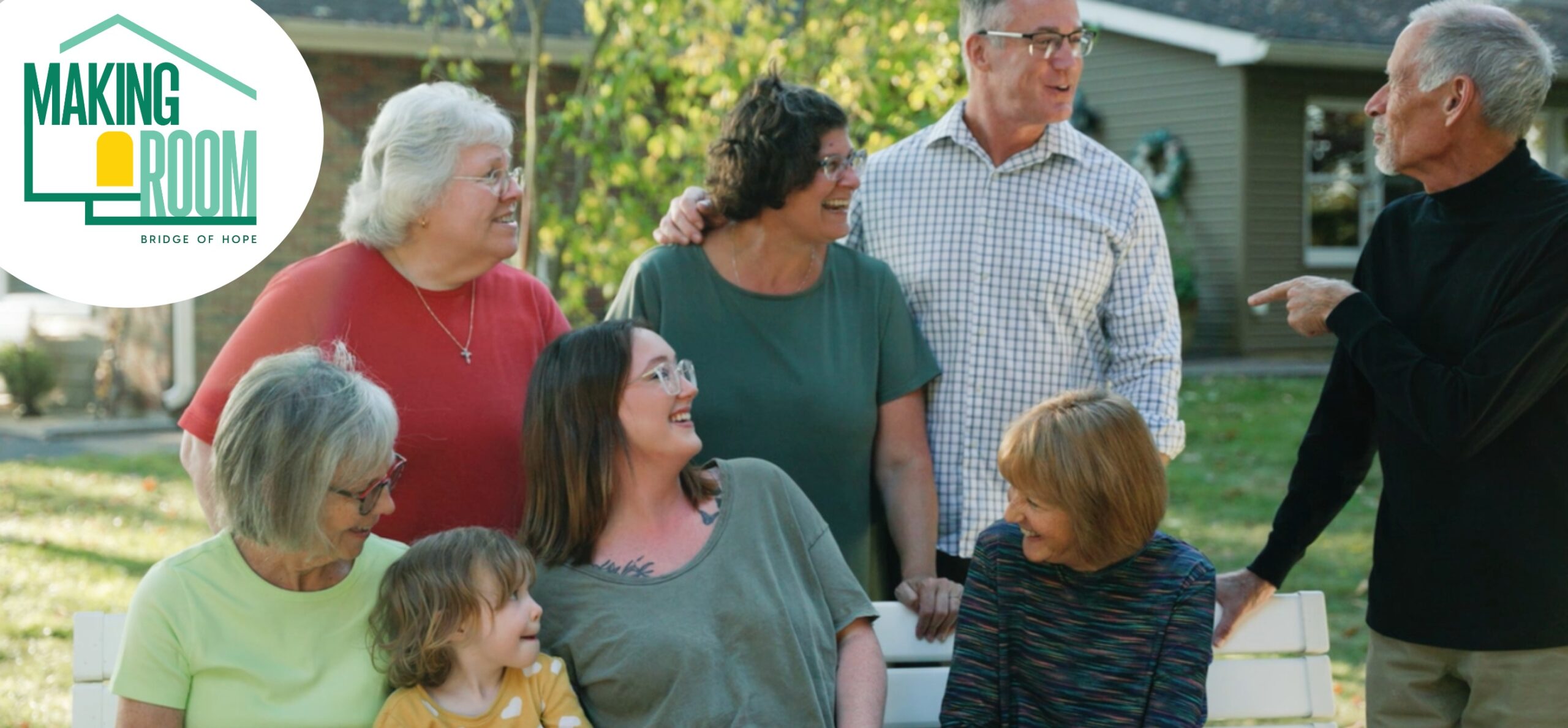group of Neighboring Volunteers talking with a single mom and her kids